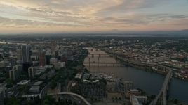 5K aerial stock footage of following the Willamette River over bridges, Downtown Portland, Oregon, twilight Aerial Stock Footage | AX54_095E