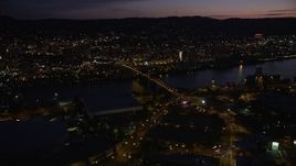 5K aerial stock footage approach the Steel Bridge to reveal skyscrapers in Downtown Portland, Oregon, night Aerial Stock Footage | AX55_021E
