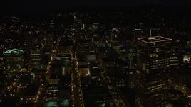 5K aerial stock footage of flying by US Bancorp Tower, and toward Wells Fargo Center, Downtown Portland, Oregon, night Aerial Stock Footage | AX55_053E