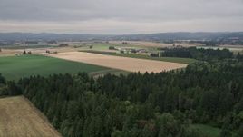 5K aerial stock footage fly over crop fields to approach a farm in Hillsboro, Oregon Aerial Stock Footage | AX56_001E