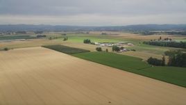 5K aerial stock footage fly over crop fields to approach a farm in Hillsboro, Oregon Aerial Stock Footage | AX56_002