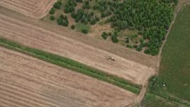5K aerial stock footage of bird's eye view of a tractor plowing a field, Banks, Oregon Aerial Stock Footage | AX56_012