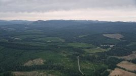 5K aerial stock footage pass evergreen forest and wide clear cut areas in Washington County, Oregon Aerial Stock Footage | AX56_019