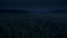 4K day for night color corrected aerial stock footage of evergreen forest, reveal a hillside clear cut area in Clatsop County, Oregon Aerial Stock Footage | AX56_044_DFN