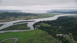5K aerial stock footage approach and pan across the Youngs River with farm fields by the water in Astoria, Oregon Aerial Stock Footage | AX56_066E