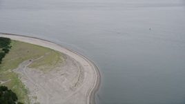 5K aerial stock footage of a car parked on an empty beach by the Columbia River, Clatsop Spit, Oregon Aerial Stock Footage | AX56_082
