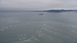5K aerial stock footage fly over Columbia River, approach oil tanker near Cape Disappointment, Washington Aerial Stock Footage | AX56_083