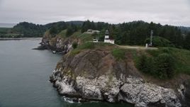 5K aerial stock footage track the Cape Disappointment Light on coastal cliffs in Washington Aerial Stock Footage | AX56_089