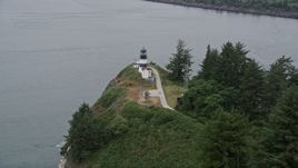 5K aerial stock footage of Cape Disappointment Light overlooking the ocean in Washington Aerial Stock Footage | AX56_096