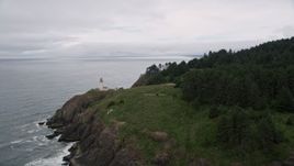5K aerial stock footage of flying away from North Head Light on a coastal cliff, Ilwaco, Washington Aerial Stock Footage | AX56_112
