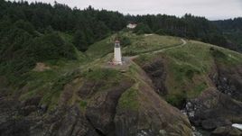 5K aerial stock footage orbit North Head Light on a cliff overlooking the Pacific Ocean, Ilwaco, Washington Aerial Stock Footage | AX56_115E