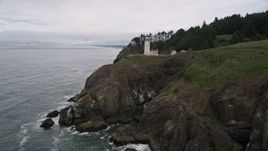 5K aerial stock footage approach the North Head Light on a steep cliff in Ilwaco, Washington Aerial Stock Footage | AX56_118E