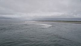 5K aerial stock footage of crashing ocean waves near an empty beach in Seaview, Washington Aerial Stock Footage | AX56_126E