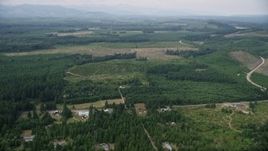 5K aerial stock footage of rural homes and a country road beside logging areas in Mason County, Washington Aerial Stock Footage | AX57_028