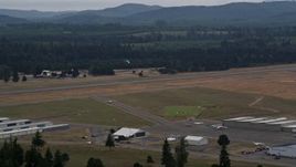 5K aerial stock footage of skydiver coming in for a landing at Sanderson Field airport, Shelton, Washington Aerial Stock Footage | AX57_039