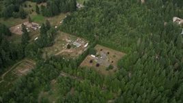 5K aerial stock footage tilt to a bird's eye view of rural homes and evergreen trees in Grapeview, Washington Aerial Stock Footage | AX58_013