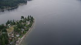 5K aerial stock footage of sailboat on Case Inlet beside Reach Island waterfront homes, Grapeview, Washington Aerial Stock Footage | AX58_023