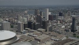 5K aerial stock footage fly over Superdome and New Orleans arena to approach skyscrapers in Downtown New Orleans, Louisiana Aerial Stock Footage | AX59_030