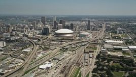 5K aerial stock footage approach the freeway interchange by the Superdome, and Downtown New Orleans skyscrapers, Louisiana Aerial Stock Footage | AX59_039