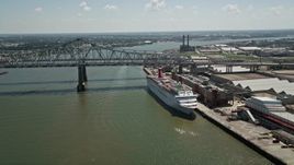 5K aerial stock footage of cruise ship docked beside the Crescent City Connection Bridge, New Orleans, Louisiana Aerial Stock Footage | AX59_043