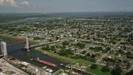 5K aerial stock footage of barges in Industrial Canal and Lower Ninth Ward homes in New Orleans, Louisiana Aerial Stock Footage | AX59_048E