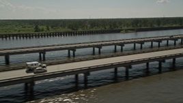 5K aerial stock footage of Interstate 10 with light traffic on the shore of Lake Pontchartrain in Norco, Louisiana Aerial Stock Footage | AX60_006