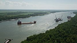 5K aerial stock footage approach and tilt to a cargo ship on Mississippi River, Louisiana Aerial Stock Footage | AX60_014E