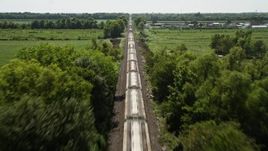 5K aerial stock footage follow railroad tracks to approach and fly over a train in Vacherie, Louisiana Aerial Stock Footage | AX60_060