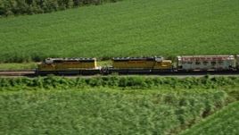 5K aerial stock footage track a train racing by sugar cane fields, Edgard, Louisiana Aerial Stock Footage | AX60_068