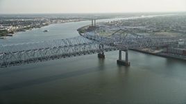 5K aerial stock footage approach Crescent City Connection Bridge spanning Mississippi River at sunset, New Orleans Aerial Stock Footage | AX61_008