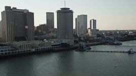 5K aerial stock footage flyby riverfront skyscrapers at sunset in Downtown New Orleans, Louisiana Aerial Stock Footage | AX61_009