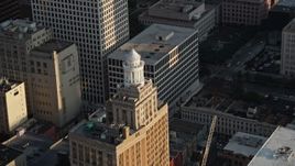 5K aerial stock footage of the top of Hibernia Bank Building at sunset, Downtown New Orleans, Louisiana Aerial Stock Footage | AX61_012