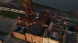 5K aerial stock footage old power plant on bank of Mississippi River at sunset, New Orleans, Louisiana Aerial Stock Footage | AX61_023