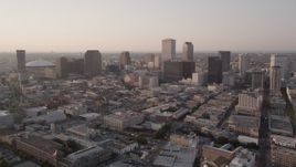 5K aerial stock footage flyby skyscrapers and approach the Plaza Tower at sunset in Downtown New Orleans, Louisiana Aerial Stock Footage | AX61_026