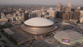 5K aerial stock footage track Superdome, reveal Downtown New Orleans skyscrapers, Louisiana, sunset Aerial Stock Footage | AX61_028