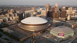 5K aerial stock footage flyby Superdome, reveal Downtown New Orleans skyscrapers, Louisiana, sunset Aerial Stock Footage | AX61_028E
