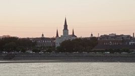 5K aerial stock footage approach St. Louis Cathedral from the Mississippi River at sunset, French Quarter, New Orleans, Louisiana Aerial Stock Footage | AX61_056E