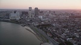 5K aerial stock footage of skyscrapers in Downtown New Orleans seen from the Mississippi River at sunset, Louisiana Aerial Stock Footage | AX61_063