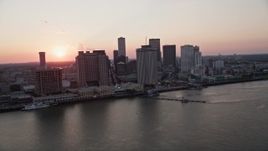 5K aerial stock footage of the setting sun behind Downtown New Orleans skyscrapers, Louisiana Aerial Stock Footage | AX61_066