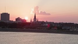 5K aerial stock footage of St. Louis Cathedral in the French Quarter of New Orleans, seen from the river at sunset, Louisiana Aerial Stock Footage | AX61_068