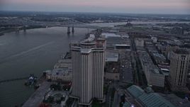 5K aerial stock footage track the World Trade Center and Hilton Riverside Hotel in Downtown New Orleans at sunset, Louisiana Aerial Stock Footage | AX61_073