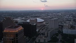 5K aerial stock footage fly over Superdome and approach freeway interchange at sunset, New Orleans, Louisiana Aerial Stock Footage | AX61_075