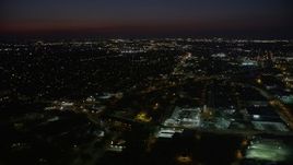5K aerial stock footage fly over Mid-City New Orleans car dealership and warehouse building to approach neighborhoods at night, Louisiana Aerial Stock Footage | AX62_003