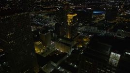 5K aerial stock footage fly over Marriott and Sheraton hotels and skyscrapers to approach Superdome at night, Downtown New Orleans, Louisiana Aerial Stock Footage | AX62_010E