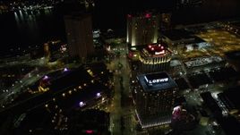 5K aerial stock footage follow Poydras Street past hotels in Downtown New Orleans at night, Louisiana Aerial Stock Footage | AX62_014