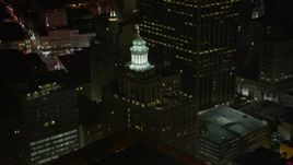5K aerial stock footage of the top of the Hibernia Bank Building at night, Downtown New Orleans, Louisiana Aerial Stock Footage | AX62_025