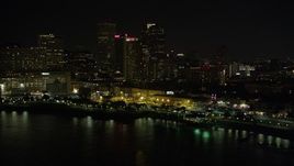 5K aerial stock footage of Downtown New Orleans skyscrapers seen from the Mississippi River at night, Louisiana Aerial Stock Footage | AX62_030