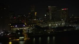 5K aerial stock footage fly low by Harrah's and hotels in Downtown New Orleans at night, Louisiana Aerial Stock Footage | AX62_035