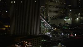5K aerial stock footage track Harrah's New Orleans and reveal Canal Street at night, Downtown New Orleans, Louisiana Aerial Stock Footage | AX62_038