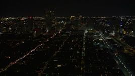 5K aerial stock footage of Bourbon Street and Downtown New Orleans at night seen from the French Quarter, Louisiana Aerial Stock Footage | AX62_040